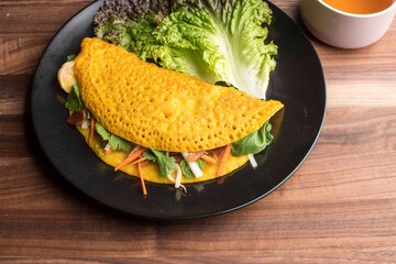 Omelette made with bacon, ham, sausage, bell peppers, heirloom tomatoes, spinach, onions, cheddar & Swiss cheese. Served with crispy potato hash, a classic American breakfast or brunch favorite.