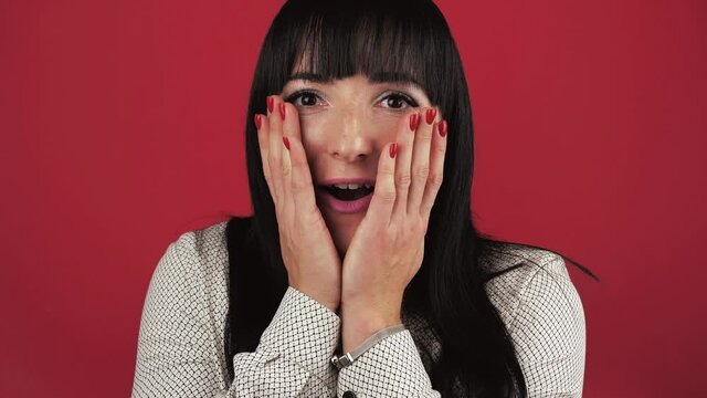 Portrait Of Surprised amazed Adult Woman over red background. Big discount concept