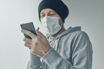 Covid-19 patient using mobile phone for communication while being self-isolated in quarantine