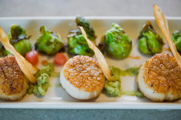 Scallops. Sautéed scallops seared in butter, garlic, shallots, red wine, tarragon, salt and pepper and served with toasted baguettes. Classic French bistro entree.
