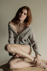 Portrait of pretty fashionable ginger woman in shirt  isolated over white background. Sexy lady