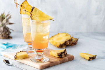 Pineapple Sunrise Mimosas ready for drinking with copy space to the right.