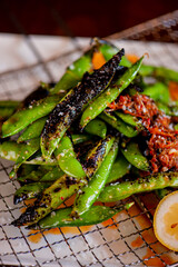 Edamame. Classic Japanese side dish served at Izakaya restaurants. Edamame boiled in brine, seasoned with garlic, lemons and coarse sea salt.