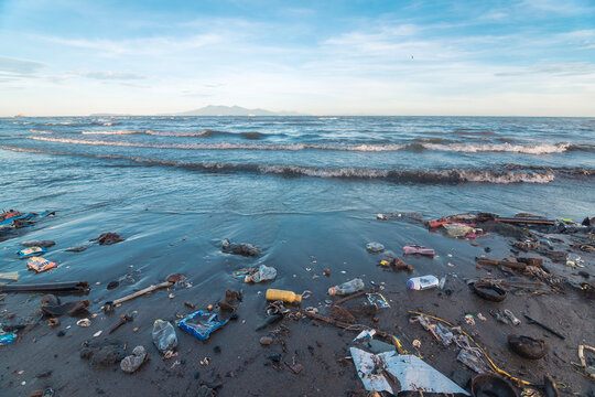 Naic, Cavite, Philippines - An extremely polluted beach littered with garbage and other debris deposited by the waves. Early morning shot. Part of Manila bay.