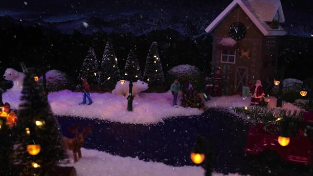 Christmas and New Year 2021. It is snowing in Christmas village, magical winter scenery. Stop motion footage with model of festive Christmas city. Holiday greetings.