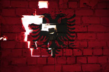 colorful painted national flag of albania on a craked old brick wall