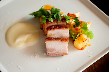 Pork belly. Pork seasoned with cracked black pepper and served with classic steakhouse side dishes: asparagus and mashed potatoes. Classic Japanese izakaya fine dining entree.