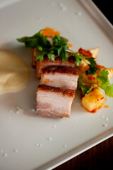 Pork belly. Pork seasoned with cracked black pepper and served with classic steakhouse side dishes: asparagus and mashed potatoes. Classic Japanese izakaya fine dining entree.