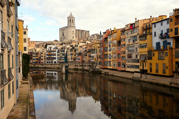 Fototapeta na wymiar View of the river Onyar and the castle in the city of Girona,.colorful buildings in the historic city center at daytime. Spain.