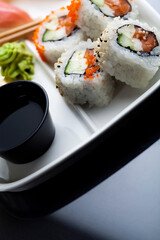 Sushi served on a white plate. Studio photo isolated. Selective focus on object. Bright light setting.