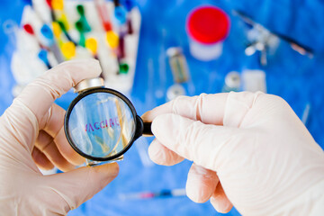 Doctor's hand whit white glove holding vaccine bottle and magnifying glass, looking and research.