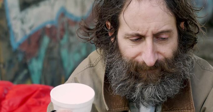 Close up of a homeless beggar man asking for money on the streets