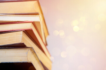 Stack of books against blue sky. Abstract Blurred nature scene backdrop concept