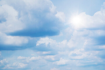 Obraz premium The sky is full of clouds floating around, both small and large, the sun is shining brightly