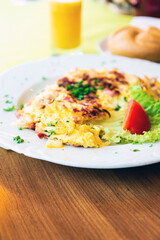 Omelet with ham, tomato and green salad
