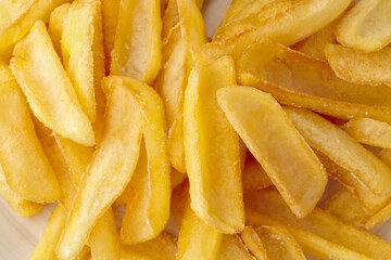 Pile of french fries on plate close up