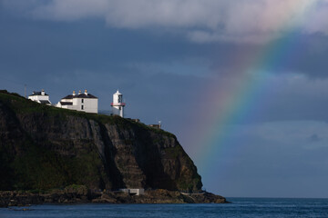 Fototapeta na wymiar Rainbow over Whitehead Lighthouse, Northern Ireland, UK