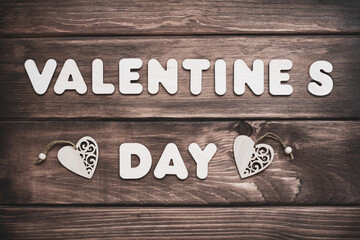 Valentine s Day vintage concept with hearts on wooden texture.