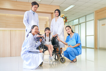 Group of doctors take care girl patient on wheelchair in hospital lobby