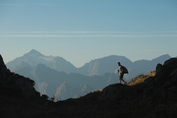 man with hiking poles in the mountains