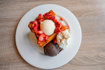 Honey Toast with sliced strawberry, vanilla, dark chocolate ice cream and whipped cream