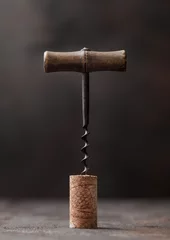 Fotobehang Wine cork with vintage corkscrew on top on wood background. © DenisMArt