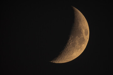 New Moon On A Black Night Sky Background. Waxing Crescent Moon With Craters