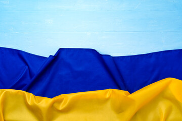 National flag of Ukraine on dark wooden background