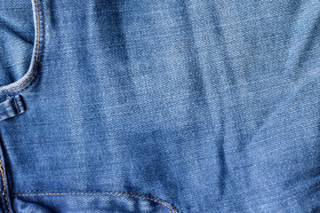 Blue jeans fabric texture. Distressed denim with front pocket background