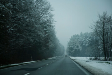 Fototapeta premium dark blurred winter road during snowstorm