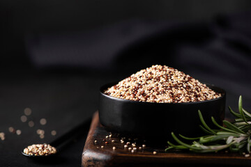 white and red quinoa grits in a black bowl