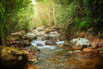 landscape Upstream waterfall in the forest with green trees in the rainy season, Beautiful waterfall in Thailand