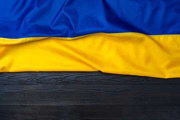 Fototapeta premium National flag of Ukraine on dark wooden background