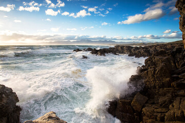 Fototapeta premium Wide Angle view of huge waves crashing in the cliffs of De Kelders of the coast of Gansbaai in South Africa