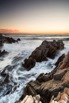 Vertical Wide angle view over the cliffs of De Kelders in Gansbaai Western Cape South Africa with stormy seas.