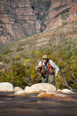 A Fly Fisherman casting to a Trout on a small Freestone stream in the Western Cape of South Africa