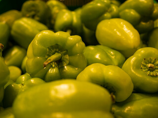 Green fresh bell peppers in a basket