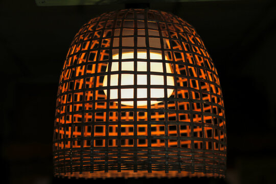 A chicken coop lamp made of bamboo and then coated with turpentine to prevent mold.