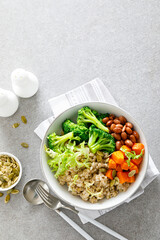 Vegan lunch bowl with pearl barley, red beans, broccoli and butternut squash