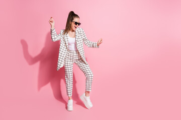 Full length photo of young crazy positive smile woman have fun enjoy music dance wear trousers isolated over pastel color background