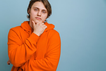 Pensive young man thinking isolated over background