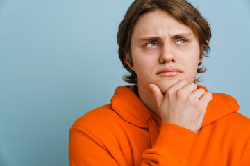 Pensive young man thinking isolated over background