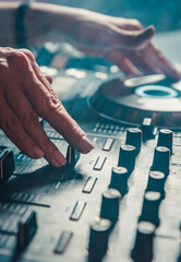 DJ Hands creating and regulating music on dj console mixer in concert nightclub stage