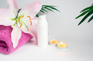 Face and body care, concept with Spa kit, towel, candles, cream on a white background. copy space