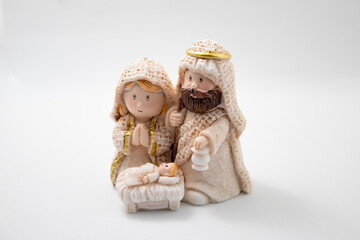 Representation of a Christmas nativity scene with the figures of baby Jesus, Mary and Joseph on a white Background. Christmas concept.