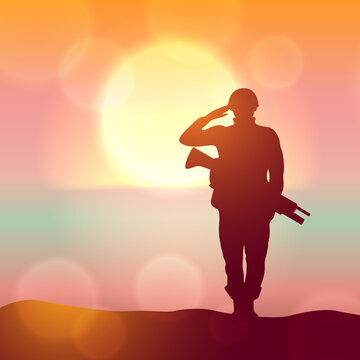 Silhouette of a solider saluting against the sunrise. Concept - protection, patriotism, honor.