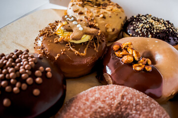 Variety of sophisticated gourmet pastry donuts with selective focus