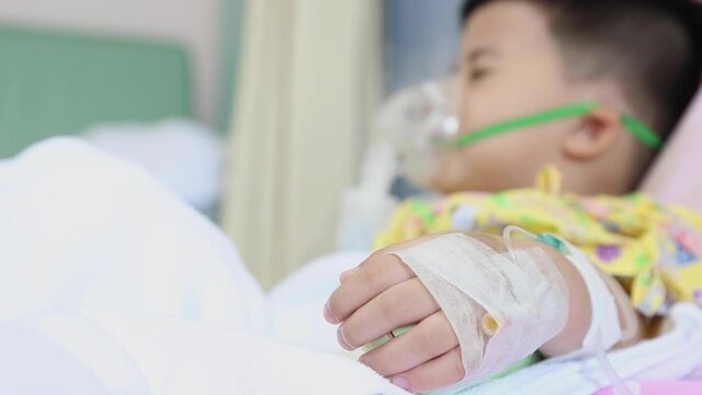 Asian little boy making inhalation with nebulizer at hospital, Nebulization concept