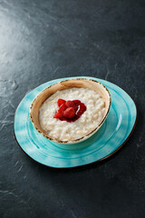 Morning oatmeal porridge with strawberry jam, European breakfast