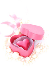 バレンタイン　ピンクのハート型チョコレートとパールとリボン